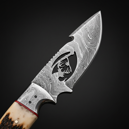 A close-up studio shot of a custom fixed-blade knife against a dark background. The knife features a Damascus steel blade with a cutout of a deer head, a red accent line near the bolster, and a dual-toned bone handle.