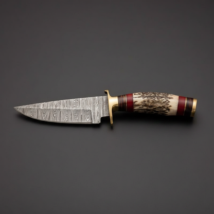 Damascus hunting fixed blade knife with hidden tang and stag horn handle on a clean charcoal background