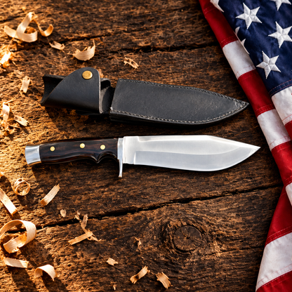Handmade carbon steel survival Bowie knife dark wood handle hero flat lay on rustic dark wood with American USA flag