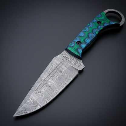 Close view of the patterned Damascus steel blade on a ring skinner knife