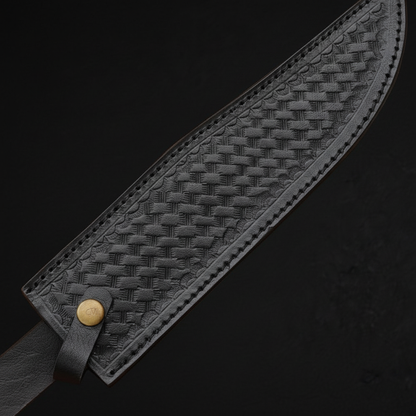 Extreme close-up of black basketweave embossed leather Bowie knife sheath diagonal angle brass snap button on black background
