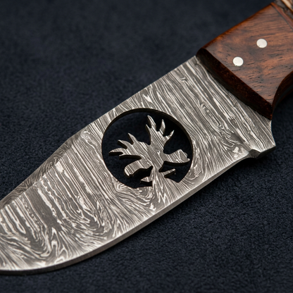 Macro of circular deer cutout and flowing Damascus blade pattern