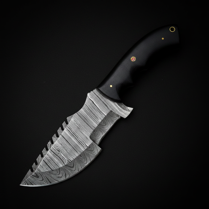 Damascus tactical tracker knife with smooth black micarta handle on deep black charcoal background studio shot
