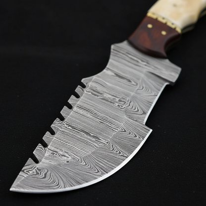 Extreme close-up of wide Damascus steel tracker blade flowing layered pattern on black charcoal background