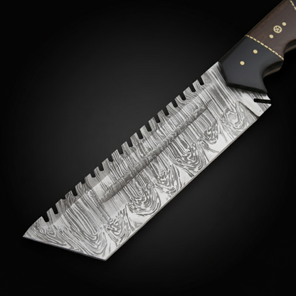 Close view of the patterned sawback Damascus blade with part of the Micarta hardwood handle and brass guard