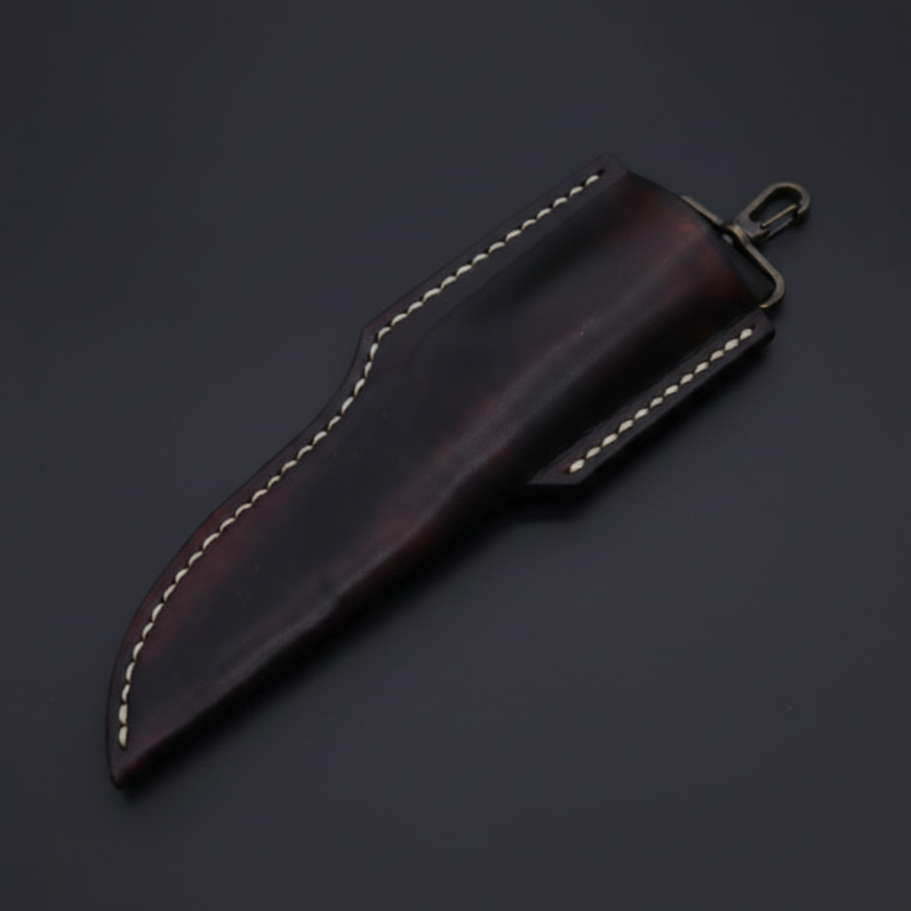 Dark brown leather sheath with brass hanger clip diagonal angle on deep black charcoal background macro shot