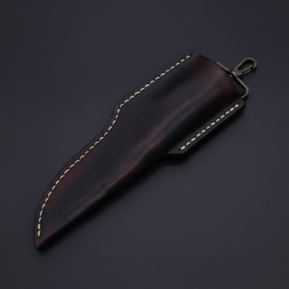 Dark brown leather sheath with brass hanger clip diagonal angle on deep black charcoal background macro shot