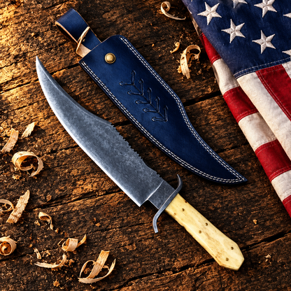 Handmade carbon steel Juan Padilla Bowie knife camel bone handle hero flat lay on rustic dark wood with American USA flag