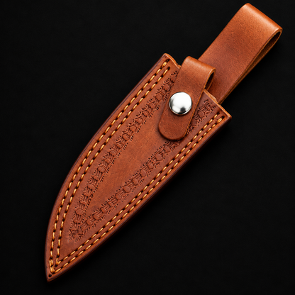 Extreme close-up of tan cognac embossed genuine leather skinner knife sheath with snap button full sheath visible on black background