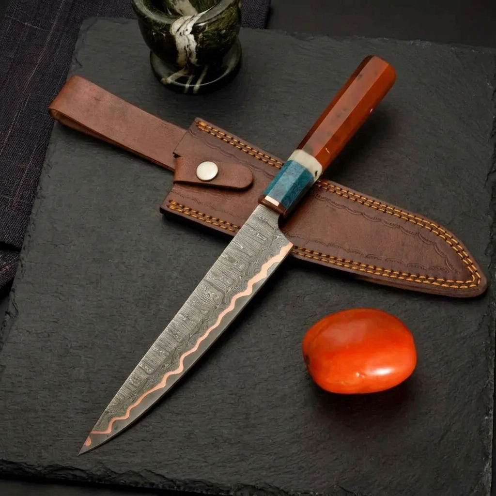 Copper Damascus chef knife editorial composition with kitchen ingredients