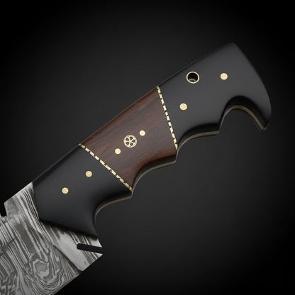 Close view of the two tone black Micarta and hardwood handle with brass pins and filework spacers