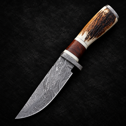 Handmade Damascus steel skinner knife stag horn handle studio shot deep black charcoal background