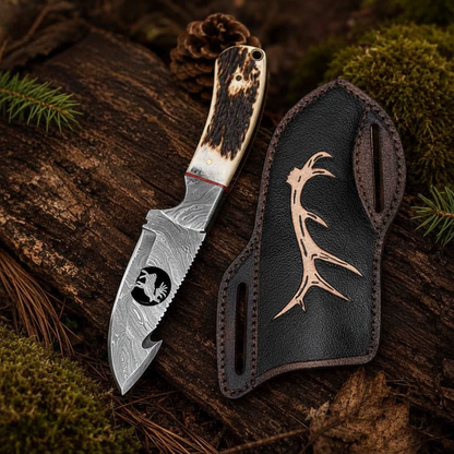 Damascus steel hunting knife with stag horn handle resting on mossy log in forest camping scene