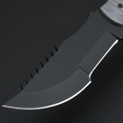 Close-up of the black powder-coated high-carbon steel blade on a J2 tracker hunting knife