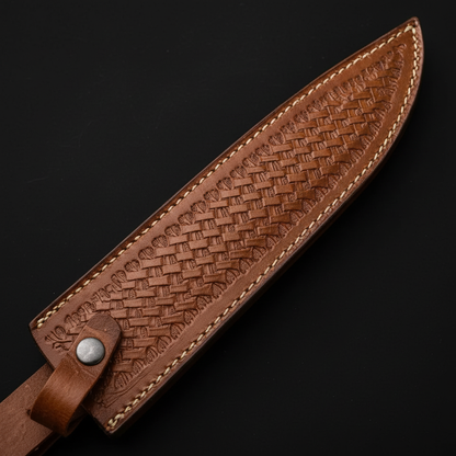 Extreme close-up of brown basketweave embossed genuine leather Bowie knife sheath diagonal angle on pure black background