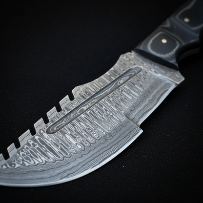 Extreme close-up of Damascus steel blade with fuller groove and flowing layered pattern on charcoal background