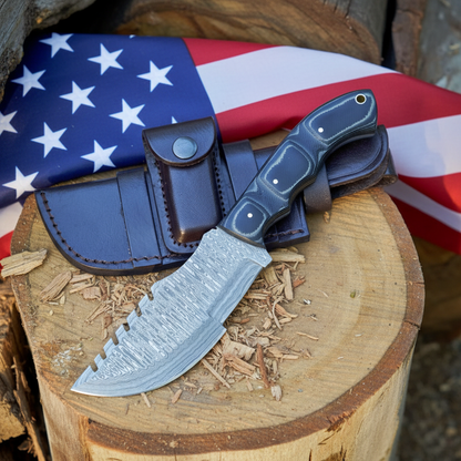 Damascus tracker knife with black micarta handle on rustic wood surface with American flag background