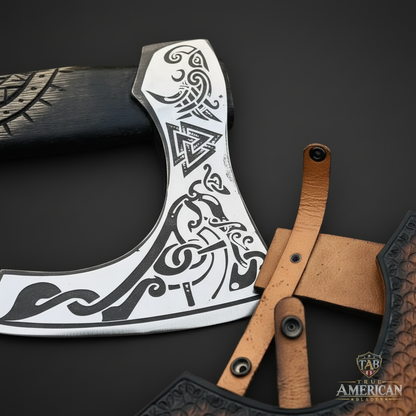Close detail of the silver-tone decorative engraving on a Viking-inspired axe head