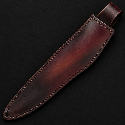 Extreme close-up of burgundy dark brown gradient genuine leather boar Bowie knife sheath full sheath visible on black background