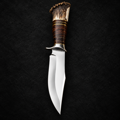 Handmade D2 steel hunting knife stacked leather handle stag antler crown tip studio shot deep black charcoal background