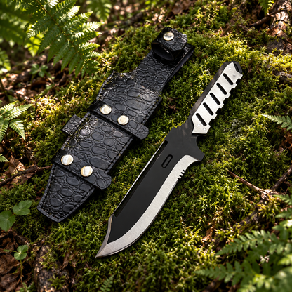 MGS4 Old Snake replica knife and black crocodile leather sheath resting on thick green forest moss natural outdoor setting
