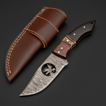 Segmented handle skinner knife and brown sheath in charcoal studio view