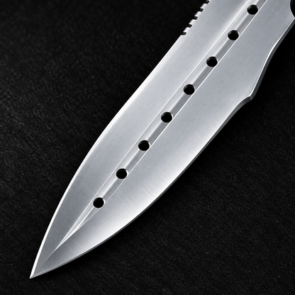 Extreme close-up of stainless steel dagger drop point blade with multi-hole blood groove circular cutouts on deep black charcoal background