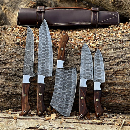 Handforged 5-piece Damascus steel kitchen chef knife set walnut handles fan display with dark brown leather roll bag on wood chips outdoor