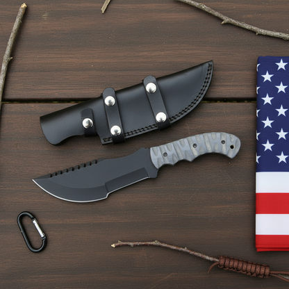 Tracker knife on dark wood with USA flag beside it
